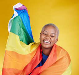 Wall Mural - Laughing, lgbtq and black woman with pride flag in studio isolated on a yellow background. Gay, homosexual and lesbian, queer or funny, happy or comic African female with banner for trans or bisexual