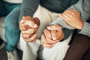 Wall Mural - Support, love and family holding hands on sofa for comforting embrace, prayer and trust together at home. Motivation, empathy and connected parents and adult children for care, compassion and praying