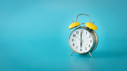 Wall Mural - Retro silver alarm clock. 6:00, am, pm. Blue background.