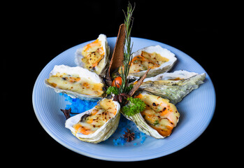 oysters baked with cheese on plate with blue salt isolated on black side view