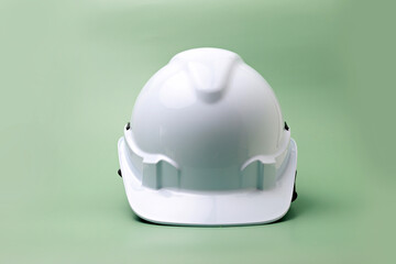 White safety helmet on green background