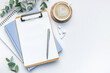 © Olena Rudo - Modern white office desk table with coffee, notebook and other supplies.