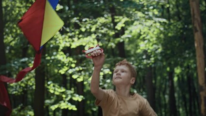 Wall Mural - Ginger boy have fun with kite at playground. Shot with RED helium camera in 8K.   