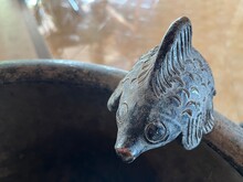 Close Up View Of Stone Fish Ornament With Unique Design On A Water Sink For Decoration.