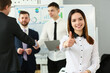 © H_Ko - Happy businesswoman feels confident in team and holds thumbs up