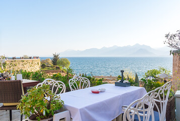 A table in a cafe on a rock by the sea.