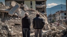 Refugees, View From The Back, Looking At Damaged Homes. Homeless People In Front Of Destroyed Home Buildings Because Of Earthquake Or War Missile Strike. Refugees, War And Economy Crisis.