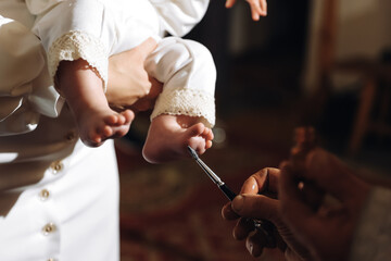 Wall Mural - The sacrament of baptism. Newborn baby during christening and chrismation