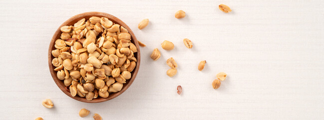 Spicy flavored peanut kernel in a bowl on white table background.