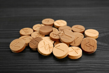 Canvas Print - Pile of runes on black wooden table