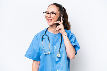 Wall Mural - Young caucasian surgeon doctor woman isolated on white background keeping a conversation with the mobile phone