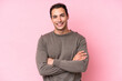 © luismolinero - Young caucasian man isolated on pink background keeping the arms crossed in frontal position
