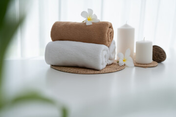 Spa accessory composition set in day spa hotel , beauty wellness center . Spa product are placed in luxury spa resort room , ready for massage therapy from professional service .