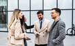 © Srdjan - Young happy confident businesspeople, owners of a small company and a new business, satisfied and motivated go to a meeting with a large corporation. Economic and marketing experts go to office work