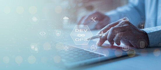 Software development, IT operations, agile programming, Concept with dev ops icon on a computer screen and project manager, coder or sysadmin typing on a keyboard, high software quality