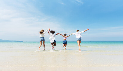 Holiday summer activity, Diverse teenage friends running into the sea. Group of friends playing on the beach. Lifestyles on vacation and holiday, Travel concept.