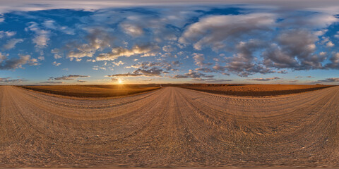 Wall Mural - 360 hdri panorama on gravel road with evening clouds on blue sky before sunset in equirectangular spherical seamless projection, use as sky replacement in drone panoramas, game development as sky dome