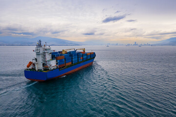 Aerial top view of cargo container vessel underway in sea. import export of global trade