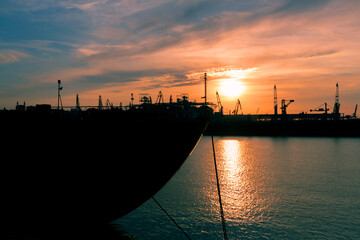 Wall Mural - sunset in industrial landscape of commercial seaport. Sunset at seaport.