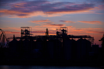 Wall Mural - sunset in industrial landscape of commercial seaport. Sunset at seaport.