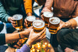 © Nicolas Micolani - Group of friends drinking and toasting glass of beer at brewery pub restaurant- Happy multiracial people enjoying happy  hour with pint sitting at bar table- Youth Food and beverage lifestyle concept