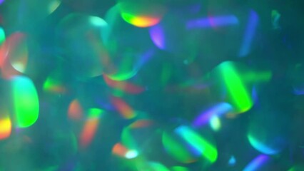Canvas Print - Background of Holographic Bokeh Reflexes motion. Abstract luminous background in shades of green with iridescent reflections. Moving particle bokeh lights.