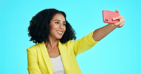 Wall Mural - Kiss, peace sign and selfie of woman in studio isolated on a blue background. Air kissing, v hand emoji and smile of young female taking pictures for happy memory, profile picture or social media.