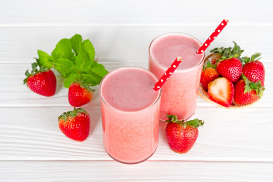 Fototapete - Strawberry yogurt fruit juice smoothie pink colorful fruit juice milkshake blend beverage healthy high protein the taste yummy In glass drink episode morning on white wood background.