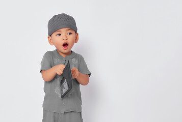 Wall Mural - Shocked toddler Asian muslim boy holding black wallet isolated on white studio background