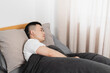 © Anciens - Asian man is sleeping in the bed.