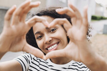 Smiling Beautiful Woman Making A Heart Shape With Hands Closeup, Pretty Joyful African American Woman Showing Heart Symbol Outside, Healthy Lifestyle, Self Love And Body Care Concept