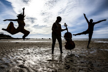 Silhouetted Dancers And Cellist On Cape Cod Beach