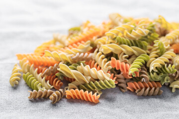 Wall Mural - A variety of fusilli pasta made from different types of legumes, green and red lentils, mung beans and chickpeas. Gluten-free pasta.