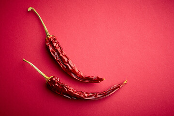 Dry hot pepper on a red background. Chilli.