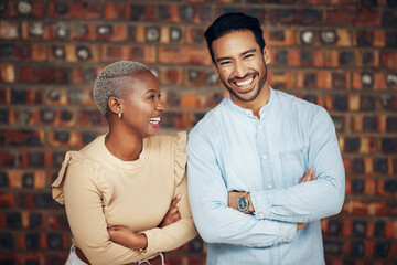 Young, professional team and partnership, laughing with teamwork and arms crossed on wall background. Happy working together, creative pair and diversity, black woman and man, collaboration and trust