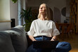 © baranq - Mindfulness concept. Worek life balance. Adult woman with laptop relaxing on the sofa with closed eyes
