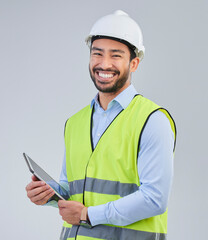 Poster - Construction worker, portrait and happy man in studio with tablet and helmet safety on white background. Smile, internet and contractor or architect in online planning for project management in India