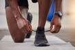 © Yusrah Abbas/peopleimages.com - Lace shoes, man and gym for workout, training and start bodybuilding performance. Closeup sports guy tie sneakers for exercise, healthy fitness and runner footwear on floor, power and athlete action
