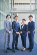 © HML - オフィスの廊下に並んで立つビジネスマンの男女