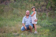 © farmuty - Bald father in glasses hugs daughter with green hair in nature. Diversity family portrait smilling. Fathers Day. Care, child care. Children Protection Day. Single parent. Travel, vacation weekend