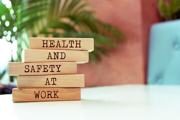 wooden blocks with words 'health and safety at work'. business concept