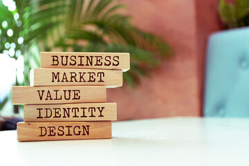 Wall Mural - Wooden blocks with words 'Business Market Value Identity Design'. Business concept