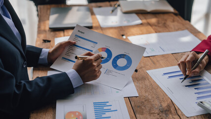 Wall Mural - Team of lawyers and tax auditors brainstorming together and calculating the balance sheet and historical financial accounts of the company and shareholders. to detect mistakes and prevent bribery