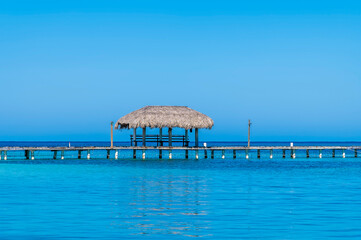 Wall Mural - A view acros a jetty close to West Bay on Roatan Island on a sunny day