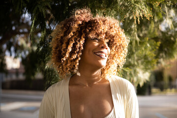 beautiful afro dominican woman laughind during sunset