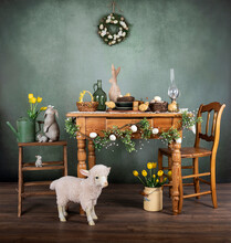 Easter Interior Decoration In An Old Vintage House With Wooden Table, Lamb, Bunnies And Baby Chickens