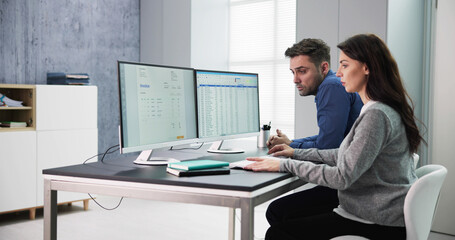 Poster - male and female auditors working on computer with invoice