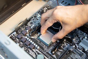 Poster - top view technician inserting cpu, computer assembler