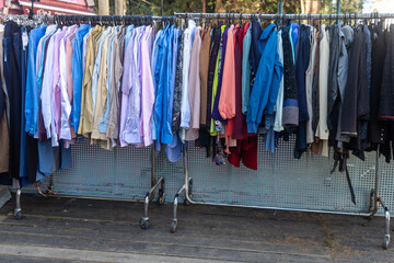 Wall Mural - Multi-colored men's shirts on the rail at entrance to the store. Vintage Charity Fair