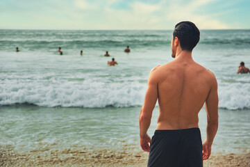 Canvas Print - Handsome young man standing on a beach in Phuket Island, Thailand